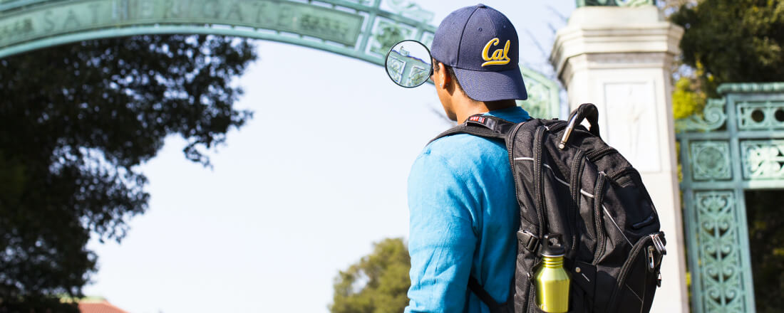 guy looking at arch through magnifying glass