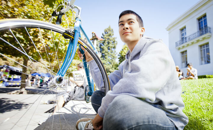 guy sitting next to his bike