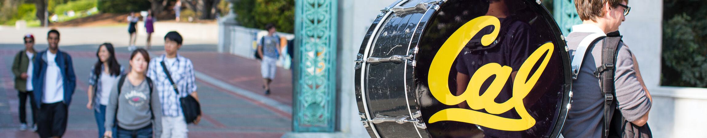 person with large bass drum instrument on their back